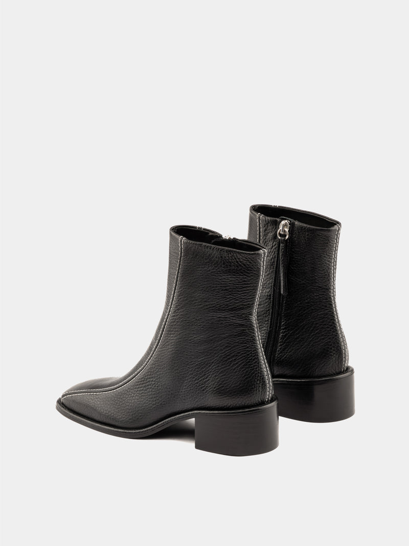 Black ankle boot with white stitching and square heel