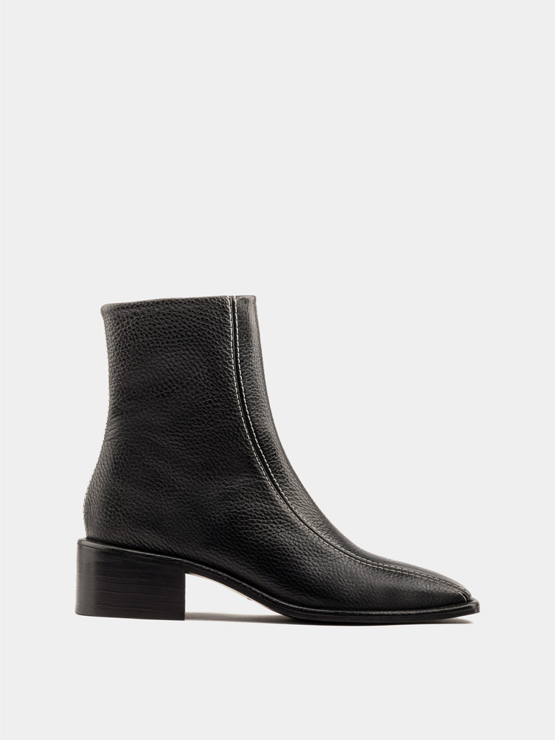 Black ankle boot with white stitching and square heel