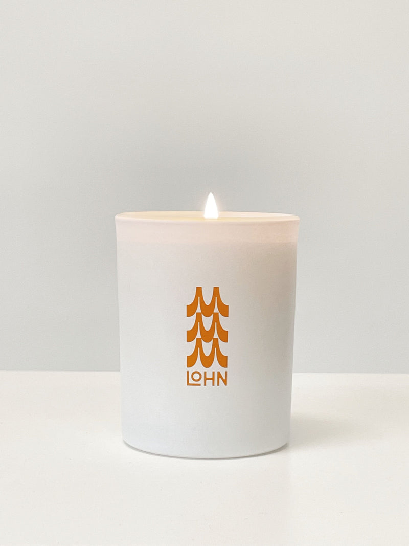 Maguire X Lohn candle on a white background