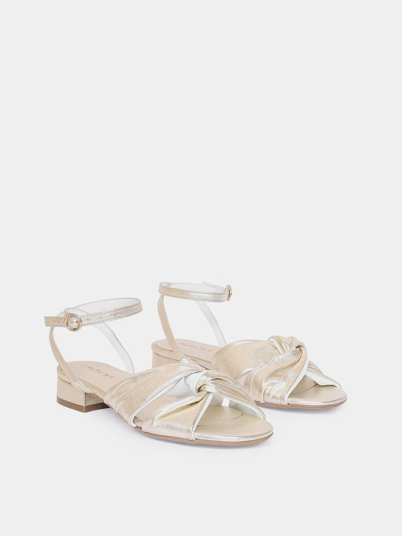 gold sandal on light gray background