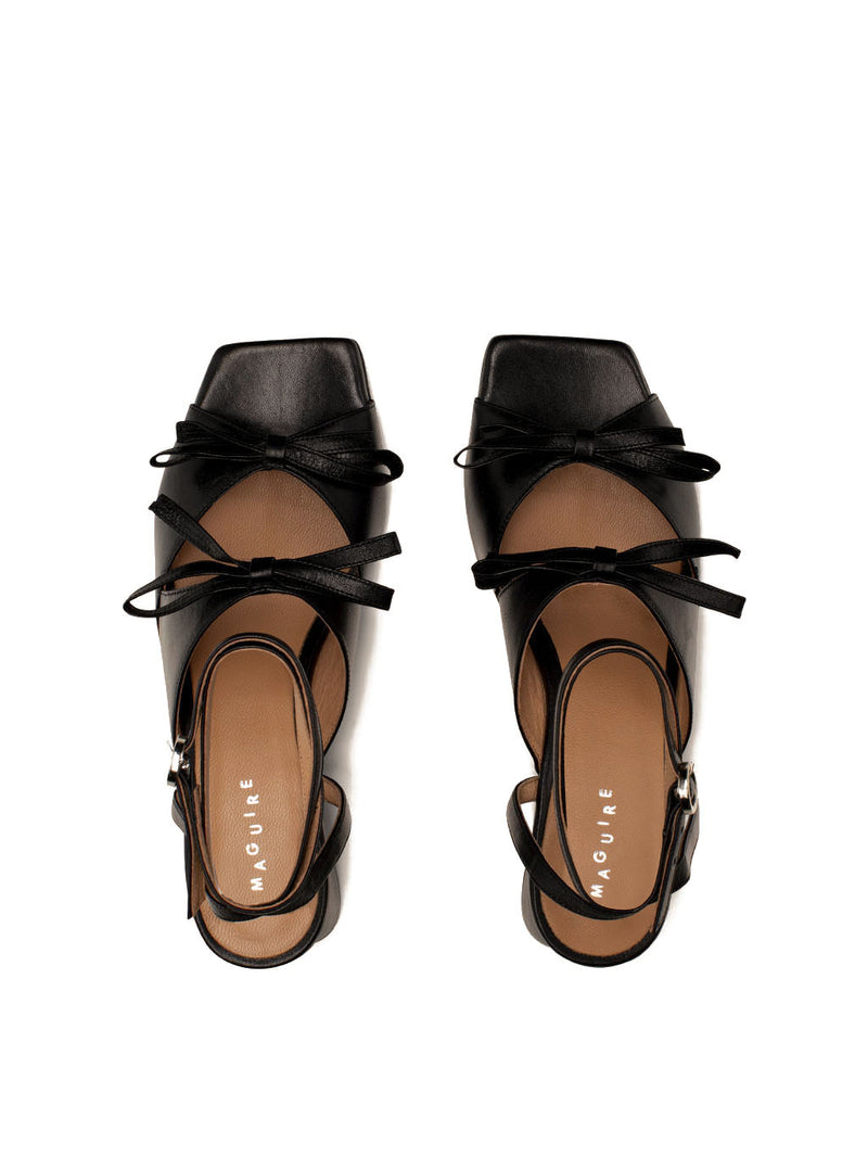 Mira black leather square-toe heel with ankle strap and two bows, top view.
