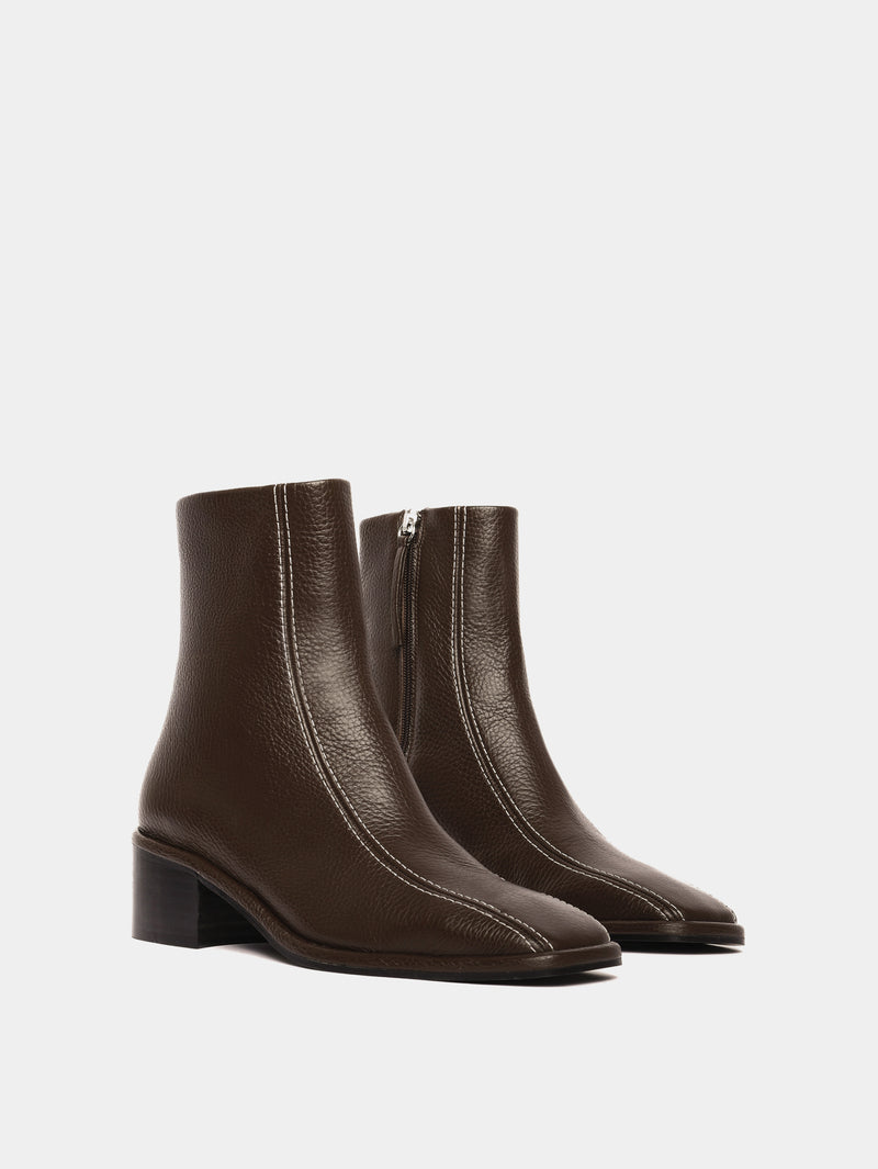 Brown leather ankle boots with white contrast stitching and a block heel