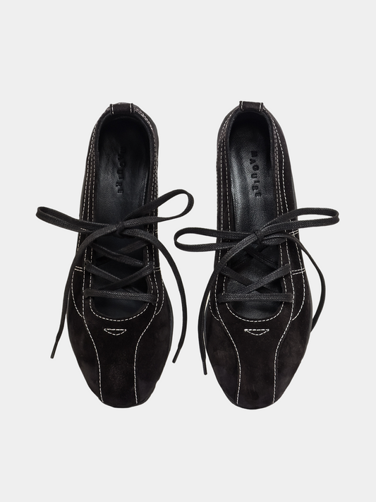 Pair of black lace-up shoes on a light gray background