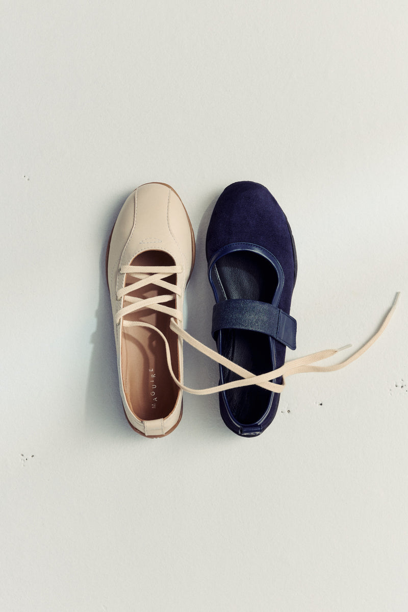 two ballet flats laying next to each other on white background