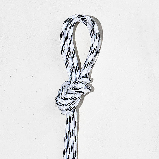 White with black laces, tied in a knot on a light gray background