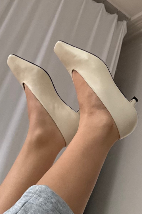 Beige Mariana heels being worn against a neutral background