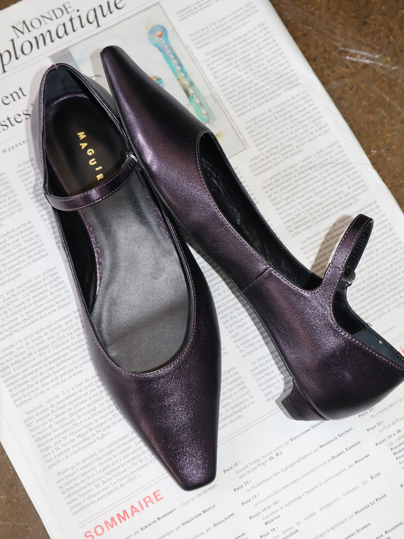 Pair of purple shoes on a newspaper background